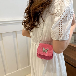 Pink mini crossbody bag with silver butterfly charm and chain strap for women