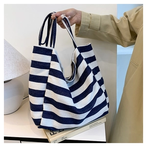 Detail of blue and white striped canvas tote bag showing thick durable fabric texture