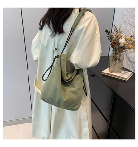 Detailed view of lightweight grass green hobo tote bag with drawstring and wide shoulder strap