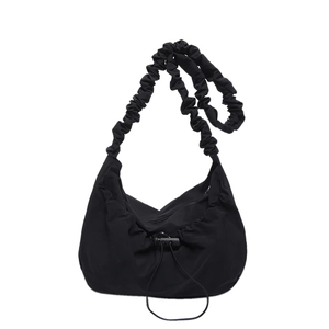 Minimalist black pleated nylon tote bag with scrunchie shoulder strap and drawstring closure