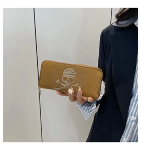 Detailed macro view of the punk skull stud patterns on a brown matte leather wallet