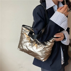 Metallic quilted tote bag with black straps and spacious interior for urban fashion