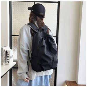Side view of black large capacity nylon backpack with adjustable shoulder straps