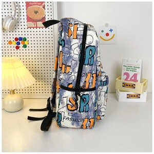 Close-up of graffiti print backpack with FASHION text in a modern desk setting