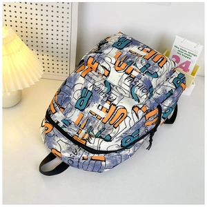 Detail of street-style graffiti backpack with fashion print and orange zip puller