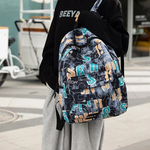 Detail view of fashion backpack featuring vibrant abstract lettering and front zipper pocket