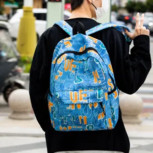 Outdoor shot of blue graffiti backpack featuring colorful street art patterns and zippers
