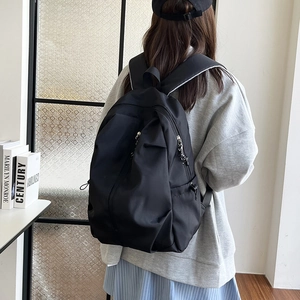 Minimalist black water-resistant nylon backpack with large capacity for daily commuting