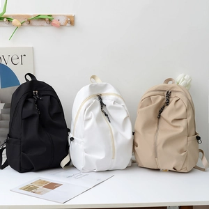 Minimalist nylon backpacks in black, white, and khaki with stylish pleated design