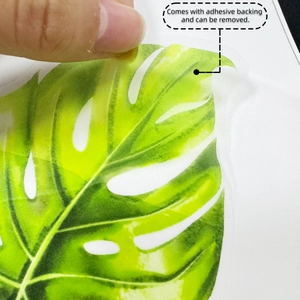 Detail showing the water-colored monstera leaf wall sticker with adhesive backing