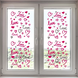 Detail of pink Love lettering and heart static window clings on glass pane