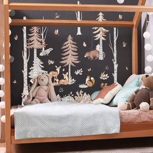 Detail of forest animal wall stickers with bears and deer on a dark nursery wall