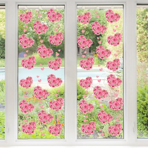 Detail of pink floral heart static cling window stickers on glass with outdoor garden view