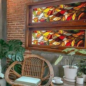 Close-up of stained glass style window film featuring colorful autumn leaf patterns