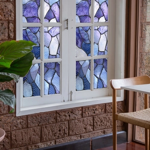 Detail of blue and purple mosaic static cling window film with wave texture
