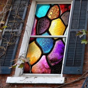 Detail of colorful pebble mosaic window film with vibrant stained glass effect texture