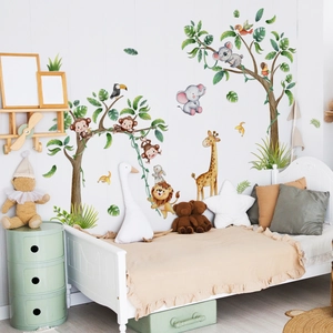 Detail of cartoon jungle wall stickers featuring hand-painted animals on a white wall