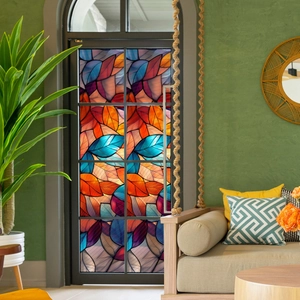 Close-up of artistic stained glass window film with colorful leaf patterns for home privacy