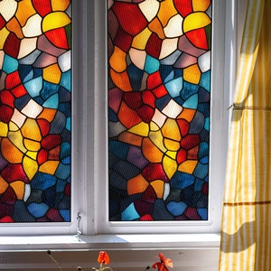 Macro shot of colorful geometric mosaic window film with frosted texture on glass