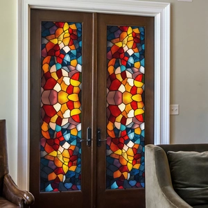 Colorful geometric mosaic window film on wooden double doors in a cozy living room decor
