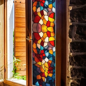 Detail of colorful irregular mosaic window film on a rustic wooden glass door frame
