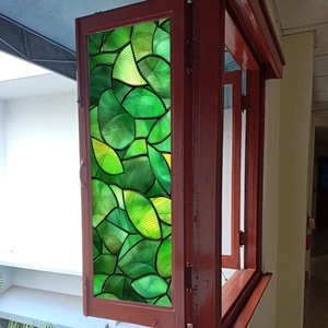 Macro detail of leaf mosaic stained glass window film with matte light transmission
