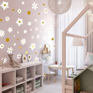 Detail of white and gold daisy wall stickers on a soft pink wall for home decor