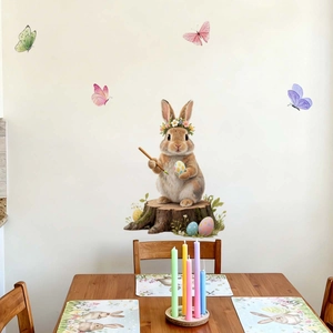 Easter wall sticker with watercolor rabbit painting eggs near a cozy table setup