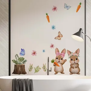 Close-up of cute watercolor Easter rabbit stickers on white bathroom wall tile