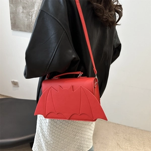 Creative red bat-wing shaped shoulder bag with leather texture and flap closure design