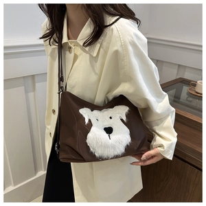 Detail of the brown PU leather crossbody bag featuring a fluffy white puppy patch decoration