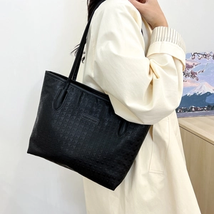 Large black tote bag for women featuring houndstooth texture and minimalist design