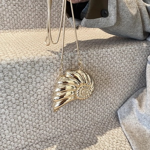 Mini golden metallic conch-shaped evening clutch bag with sleek metal snake chain strap