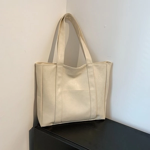 Creamy white oversized tote bag with pleated leather texture and double shoulder straps