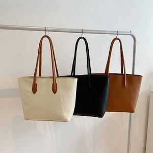 Minimalist faux leather tote bags in cream, black, and caramel for versatile daily commute