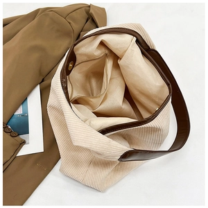 Detail view of corduroy tote bag featuring magnetic closure and inner zipper pocket