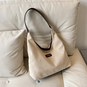 Minimalist beige corduroy tote bag with vintage brown shoulder straps and leather detail