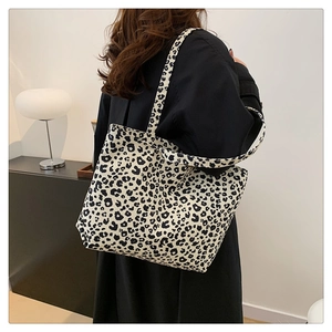 Leopard print canvas tote bag on model showing large capacity and stylish design