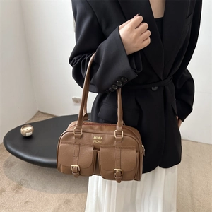 Retro brown PU leather pillow bag with double pockets and gold logo on black blazer