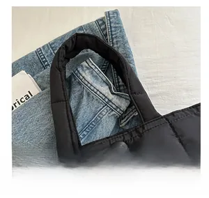 Close-up of black quilted nylon tote bag with round snap button and soft handle details