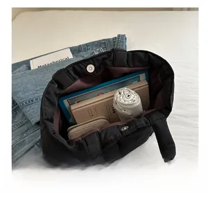 Interior view of black quilted tote bag showing large capacity for daily items