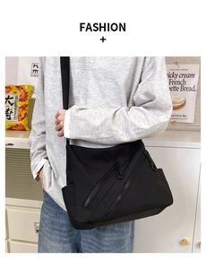 Detail of black large capacity nylon messenger bag with multiple zipper pockets