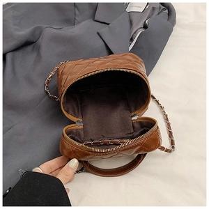 Detailed close-up of interior space and zipper of brown quilted leather crossbody bag