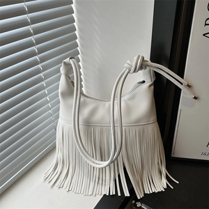 White textured leather shoulder bag featuring long fringe tassels and knotted strap design