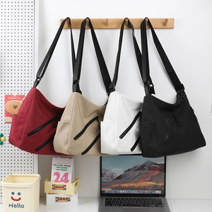 Large capacity nylon hobo bag in four colors with multiple zipper pockets and adjustable strap
