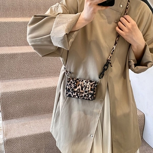 Chic leopard print crossbody bag with chain strap shown on a model for casual style
