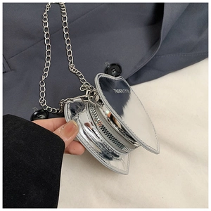 Detail of silver heart-shaped mini bag with metal chain and fashion lettering