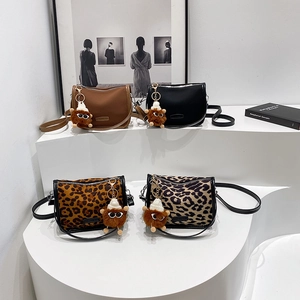Fashionable PU leather crossbody pillow bags in solid colors and leopard patterns with charms