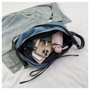Spacious blue denim tote bag organized with phone, folding umbrella, and daily cosmetics