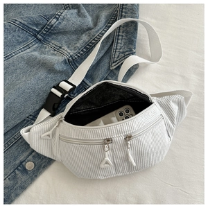 Detailed interior of a white corduroy chest bag showing large capacity for phone and essentials